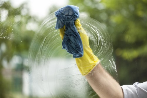 Office cleaning team sanitising desks and shared surfaces